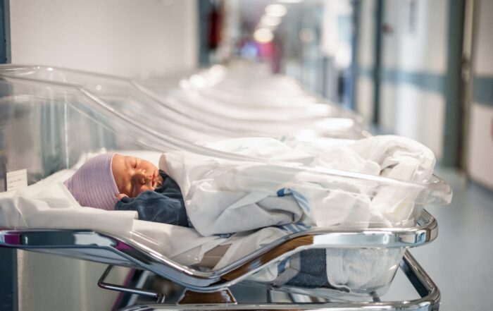 Infant in incubator in maternity ward